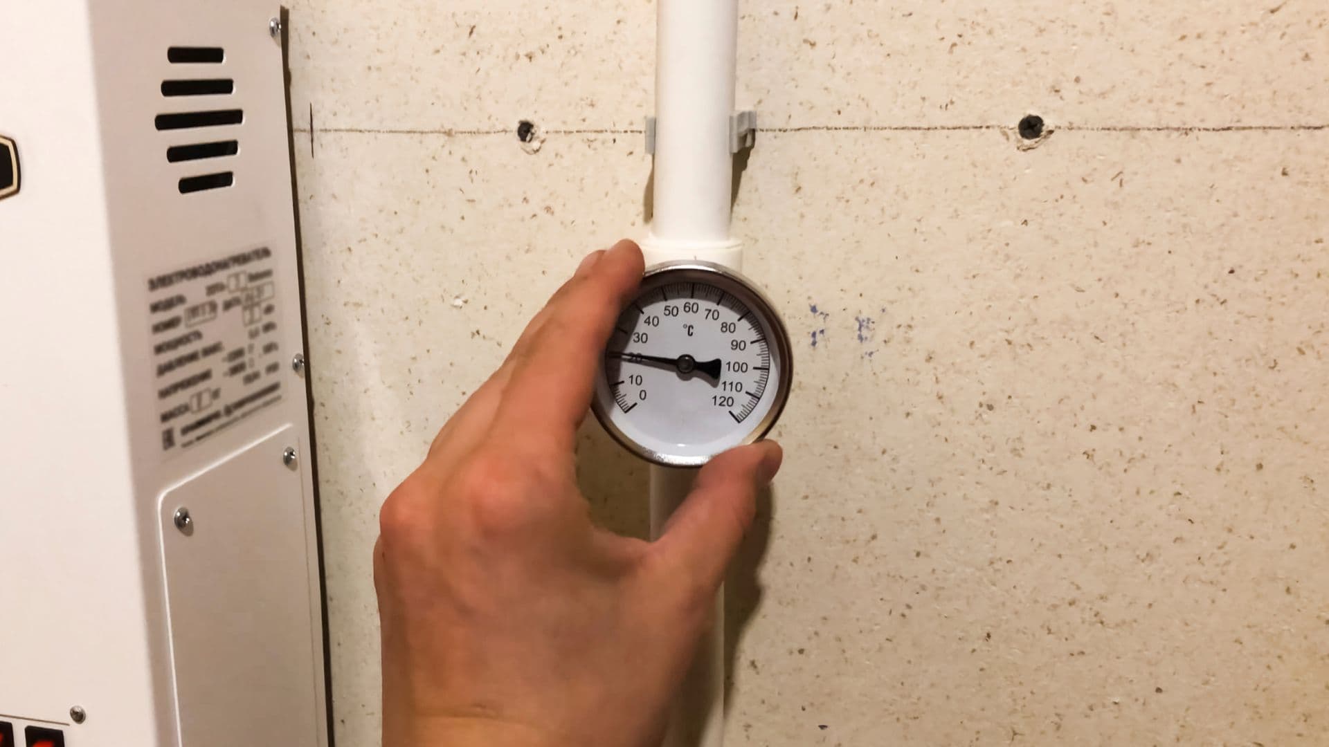 Plumber checking water pressure gauge on pipes