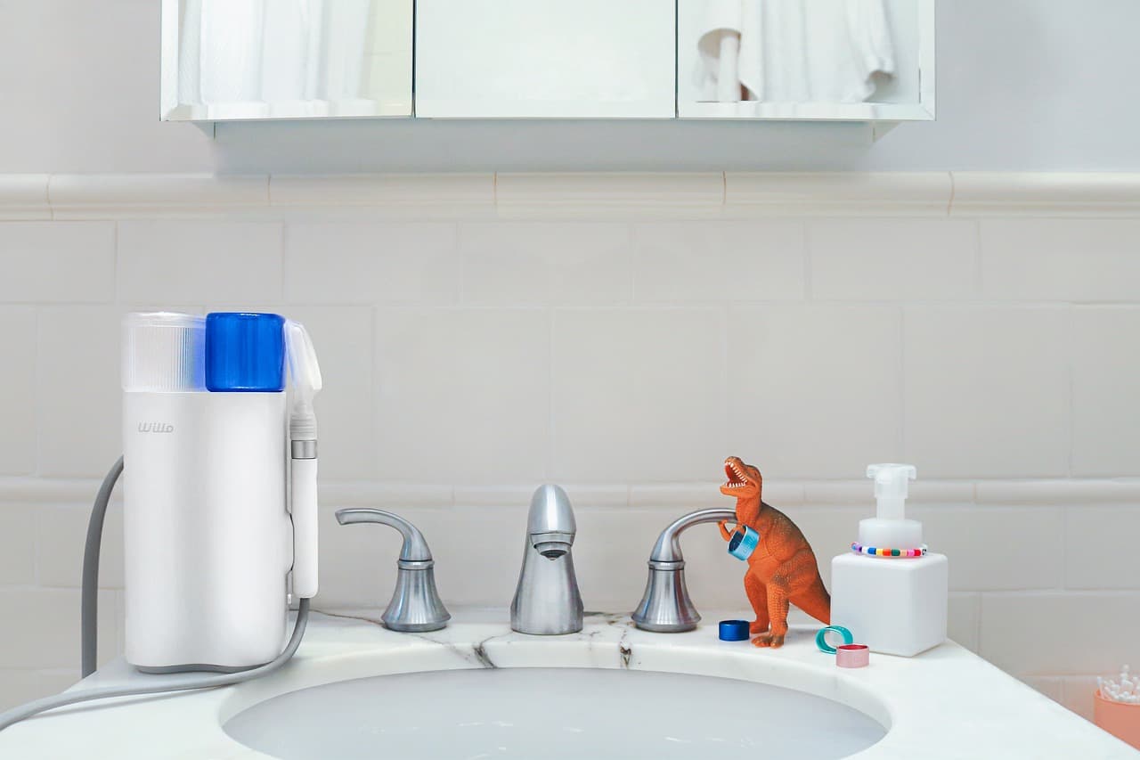 White toilet and bathroom sink in a modern residential bathroom